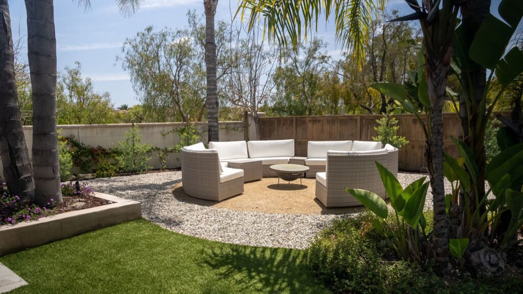 beautiful clean backyard with artificial grass and an outdoor living area