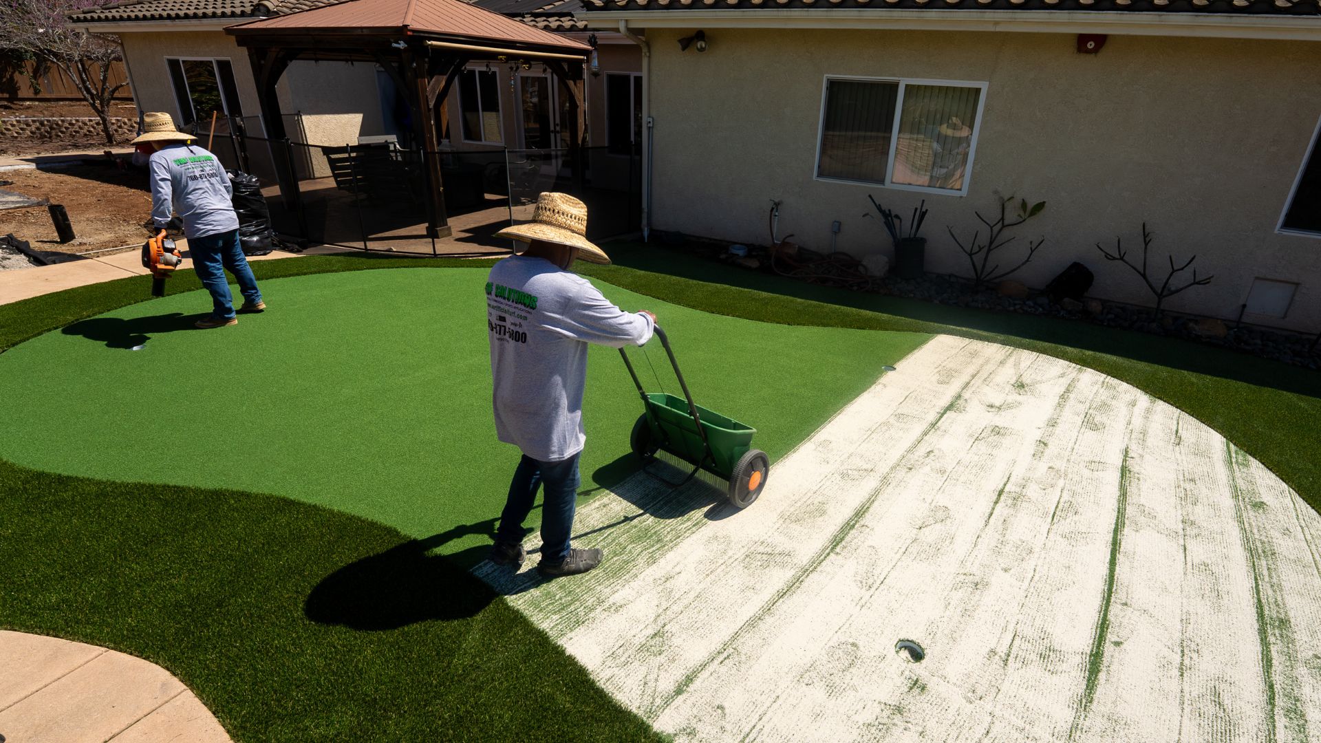 Artificial Turf Supply installation experts creating a backyard putting green