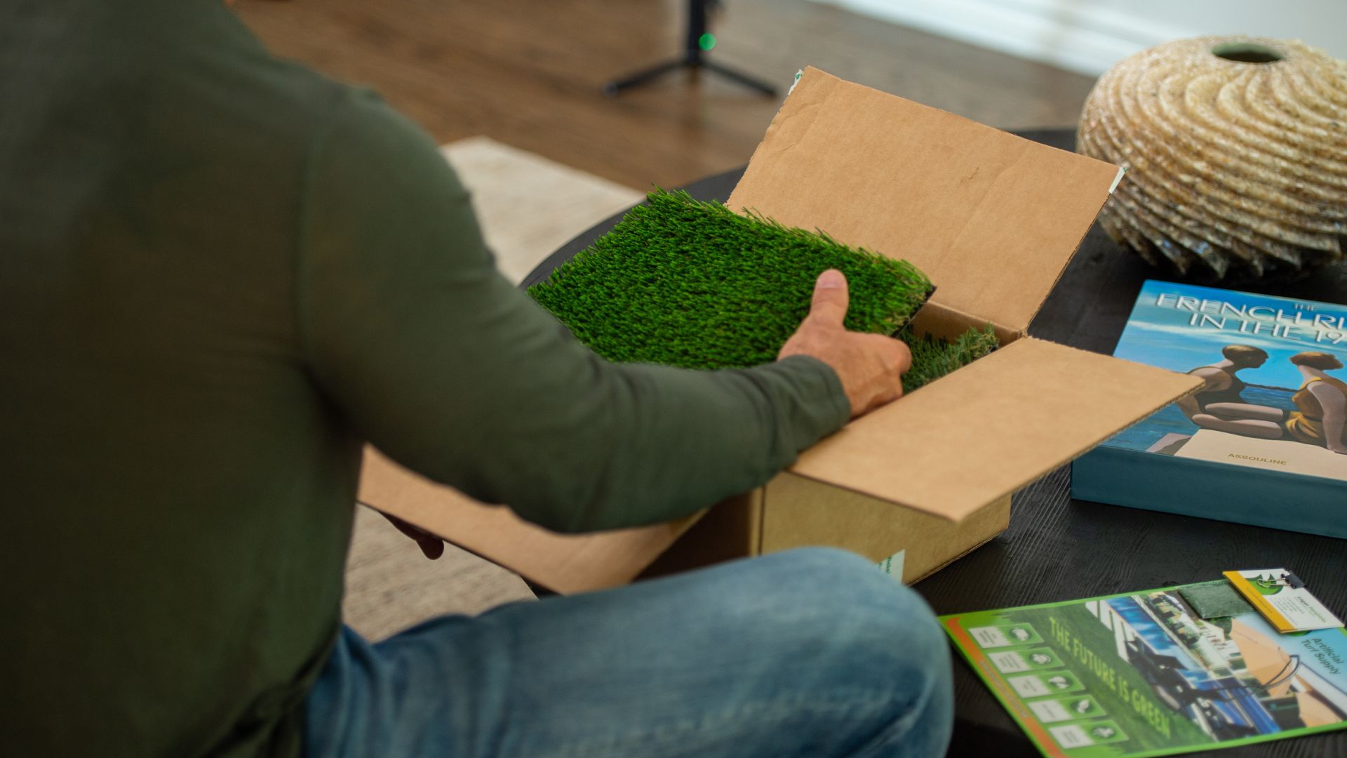 a homeowner opens a package of free turf samples from an online supplier