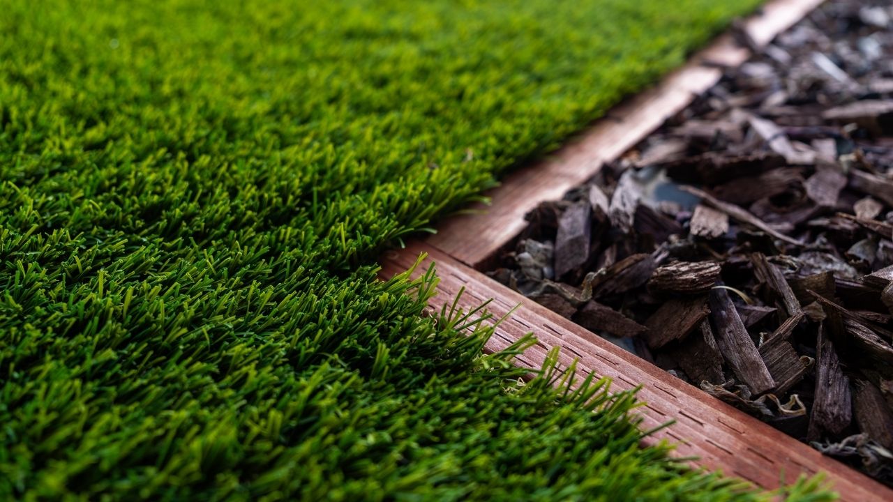 artificial turf right up against a beautiful mulch bed